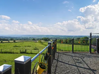 a gate with a view of a field at Sunset Holiday Pod - Uk48592 in Church Stretton