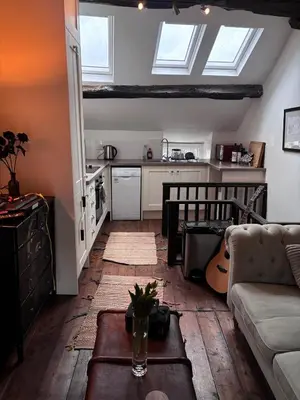 a living room with a couch and a table at The Little Laura Ashley House in Machynlleth