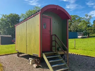 a green and red shed with a red door at Tilly - Uk49798 in Brecon