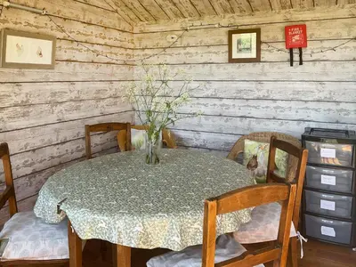 a dining room table with a vase of flowers on it at Brown Hare - Uk49799 in Brecon