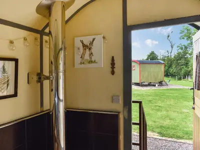 an open door to a garage with a view of a barn at Brown Hare - Uk49799 in Brecon