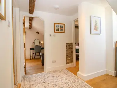 a hallway with a door leading to a living room at 10 Bridge Street in Craven Arms