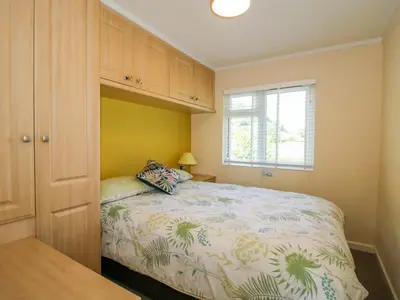 a small bedroom with a bed and a window at Dunromin in Montgomery