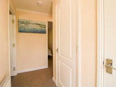 a hallway with a door and a painting on the wall at Dunromin in Montgomery