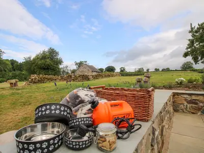 a table with food and a basket on a wall at The Long House in Oswestry