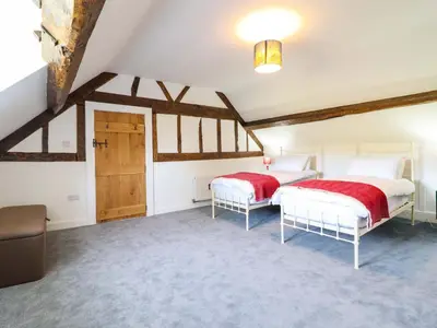 a bedroom with two beds in a attic at Upper Dolarddyn in Welshpool