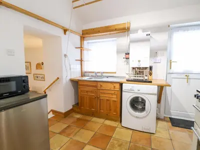 a kitchen with a washing machine and a sink at Hafan Fach in Aberystwyth