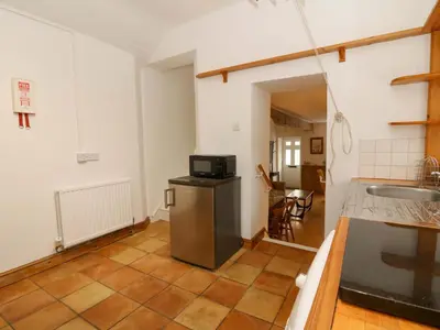 a kitchen with a sink and a microwave at Hafan Fach in Aberystwyth