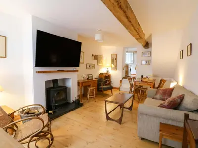 a living room with a fireplace with a flat screen tv at Hafan Fach in Aberystwyth