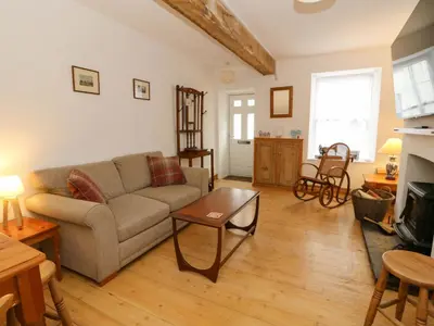 a living room with a couch and a table at Hafan Fach in Aberystwyth