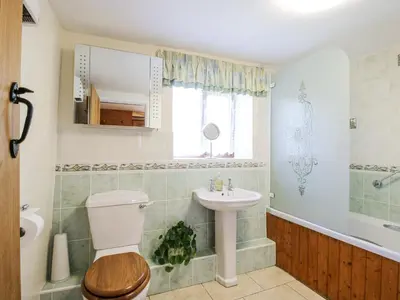 a bathroom with a toilet and a sink at Caradoc Cottage in Church Stretton