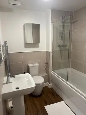 a bathroom with a toilet and a sink and a shower at Town centre abode with gated parking in Shrewsbury