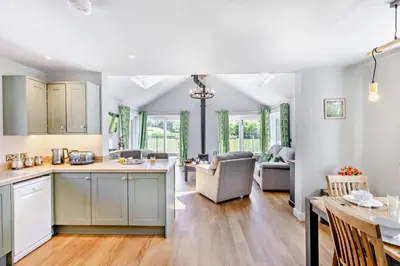 an open kitchen and living room with a table and chairs at 2 Bed in Llanarmon Dyffryn Ceiriog oc-b31110 in Llanarmon Dyffryn-Ceiriog