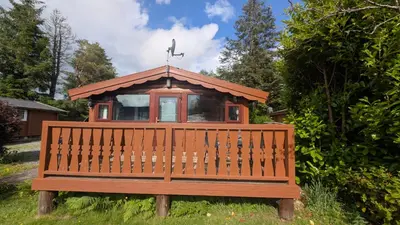 a wooden bench with a small house on top of it at Happy Place LogCabin in Trawsfynydd