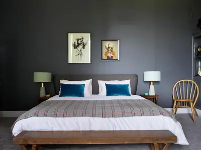 a bedroom with a large bed with blue pillows at The Royston in Llanbrynmair