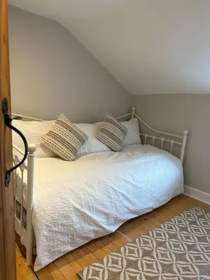 a bed with pillows on it in a bedroom at Bear cottage in Brecon
