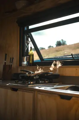 a stove in a kitchen with smoke on it at Hydra in Llangollen