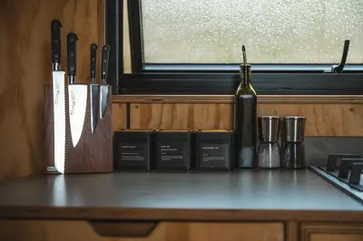 a kitchen counter with a bottle of wine and a window at Hydra in Llangollen