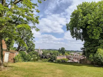 a view of a city from a field with trees at The Old House Apartment in Shrewsbury