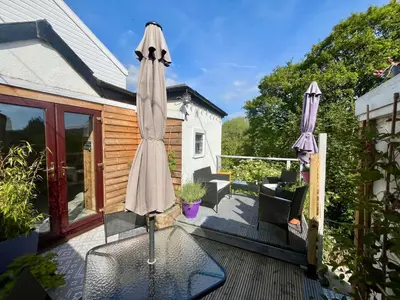 a patio with two umbrellas on a deck at Severn Up in Newtown