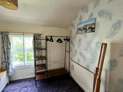 a room with a ladder and blue and white wallpaper at Severn Up in Newtown