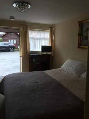 a bedroom with a bed and a window at Borderers Inn in Brecon