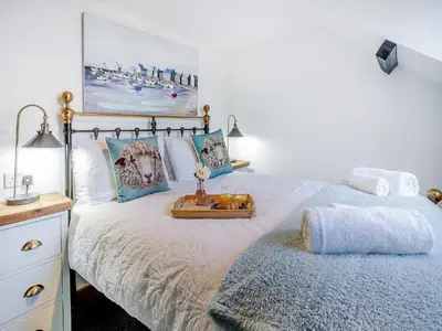 a bedroom with a bed with a tray on it at Sheep Shed - Uk49794 in Cribyn