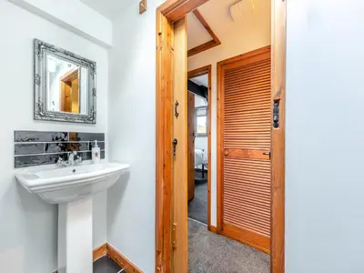 a bathroom with a sink and a mirror at Cwtch Honey - Uk49792 in Cribyn