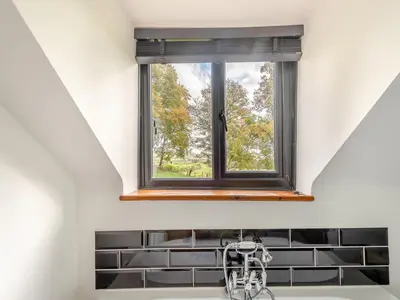 a window above a sink in a kitchen at Cwtch Honey - Uk49792 in Cribyn