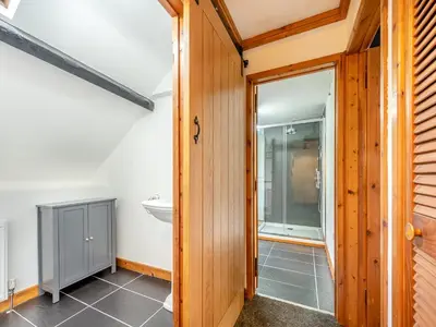 a bathroom with a glass door and a sink at Cwtch Honey - Uk49792 in Cribyn