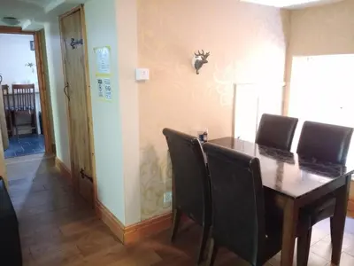a dining room with a wooden table and chairs at Chandler Ranch Llandovery Cynghordy in Cynghordy