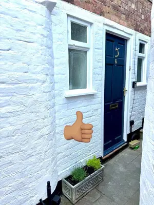 a house with a door with a hand painted on it at English Bridge Court in Shrewsbury