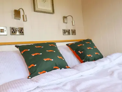 a bedroom with a bed with a pillow on it at Charollais in Oswestry