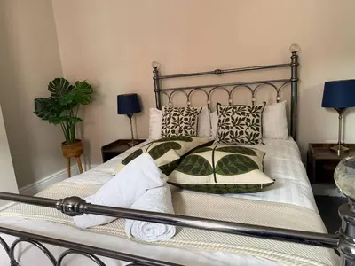 a bedroom with a large bed with pillows at Llangollen High Street 4 bedrooms Sleeps 12 in Llangollen