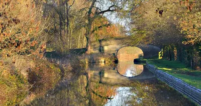 a body of water with trees and a bridge at Llangollen High Street 4 bedrooms Sleeps 12 in Llangollen