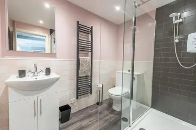 a bathroom with a toilet and a sink and a shower at Mermaids Hideaway in Aberaeron