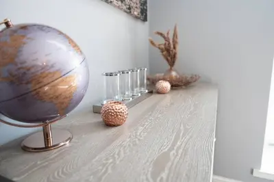 a table with a globe and glasses on it at Mermaids Hideaway in Aberaeron