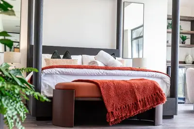 a bedroom with a bed with a red blanket on it at Ty Glyn Hotel in Ciliau-Aeron