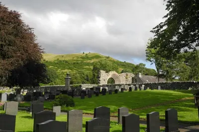 a cemetery with a hill in the background at Owls Roost Eco Lodge Apartment Lampeter in Lampeter