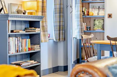 a room with a book shelf filled with books at 2 Bed in Pentre Bach oc-b30875 in Pentre-bâch