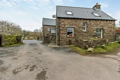 an image of a stone house with a driveway at 2 Bed in Pentre Bach oc-b30875 in Pentre-bâch