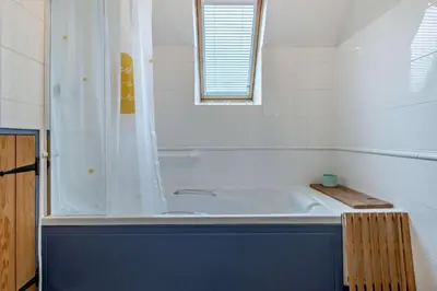 a white bathroom with a tub and a shower at 2 Bed in Pentre Bach oc-b30875 in Pentre-bâch
