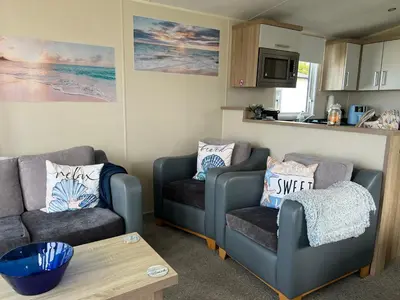 a living room with two couches and a table at Sher, My Happy super static -2026 Award winner in Llanddwywe