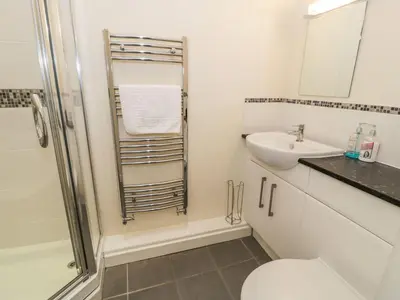 a bathroom with a toilet and a sink at 3 Riverside Bungalows in Llanbedr