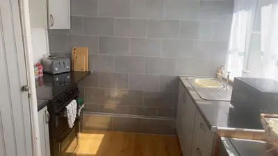 a small kitchen with a sink and a stove at Mountain View, Brecon Beacons