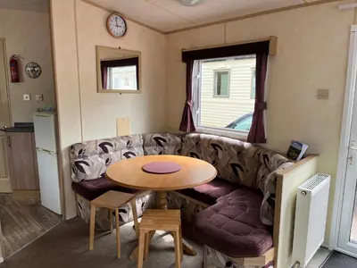 a living room with a couch and a table at Sylvan in Builth Wells