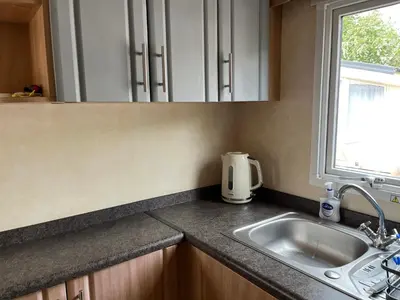 a kitchen counter with a sink and a window at Sylvan in Builth Wells