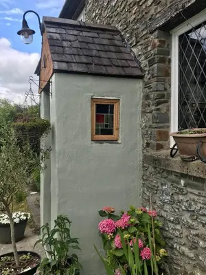 a bird house on the side of a building at Five Saints Farmhouse B&B in Pumpsaint