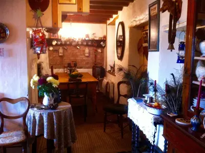 a room with a table and chairs and a kitchen at Five Saints Farmhouse B&B in Pumpsaint