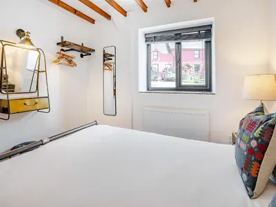 a bedroom with a bed and a window at The Old Cowsheds 5 - Llanilar - Uk49790 in Cribyn